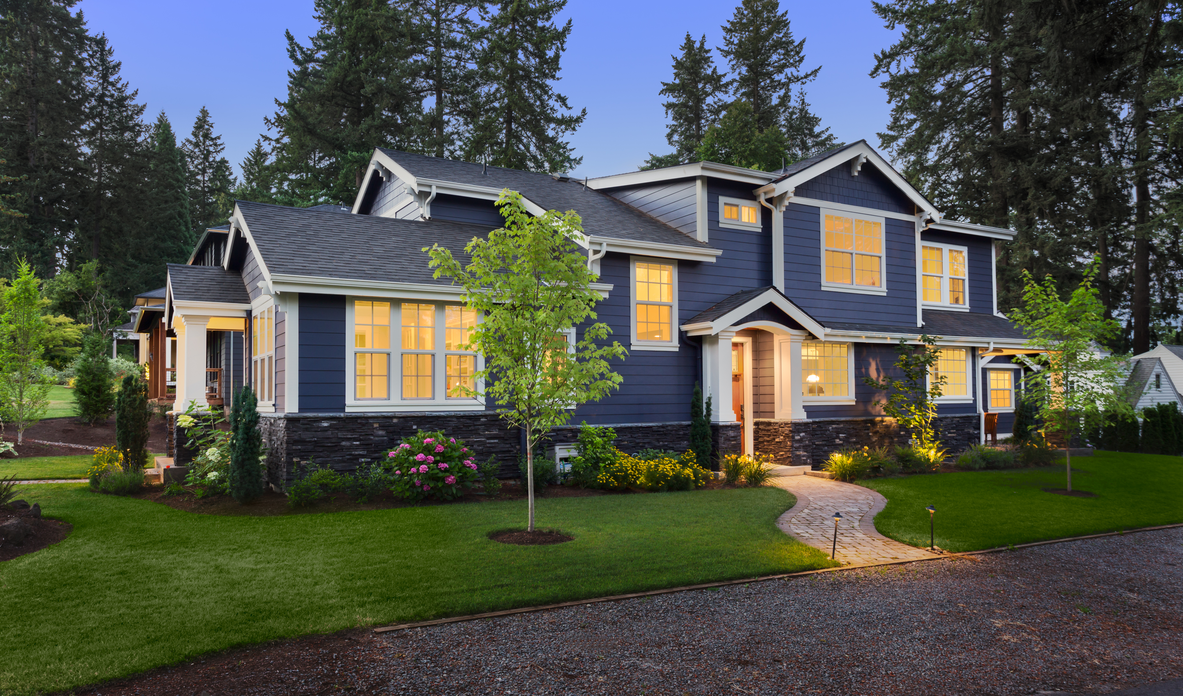 Navy blue home exterior paint with clean white trim and stone accents