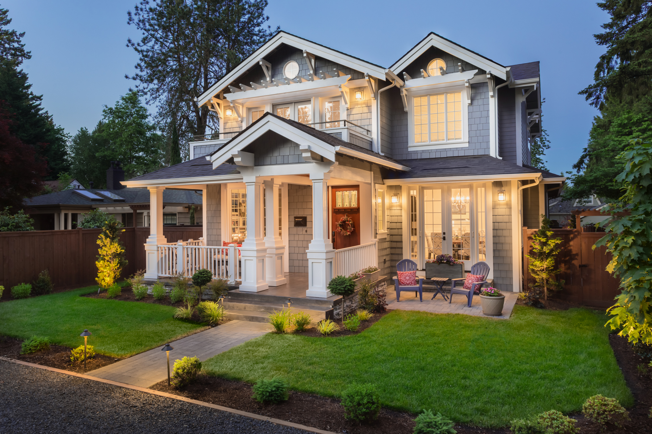 Grey house exterior painting service with white trim accents