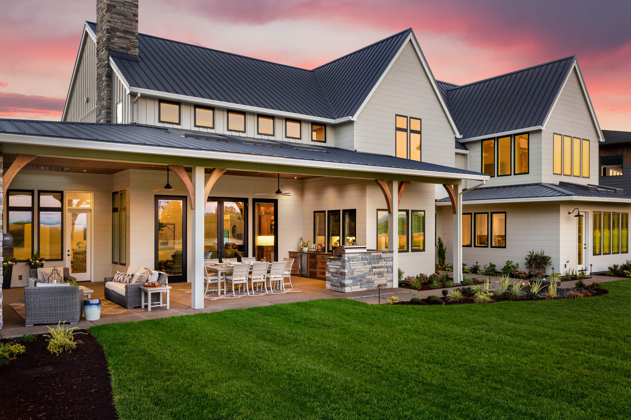 Exterior painting on modern farmhouse siding and porch beams.