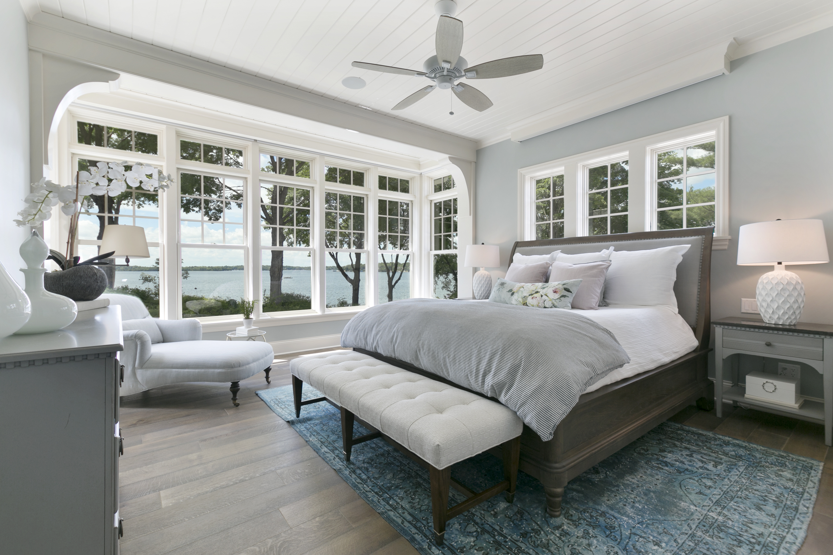 Light blue interior bedroom wall painting with white trim.