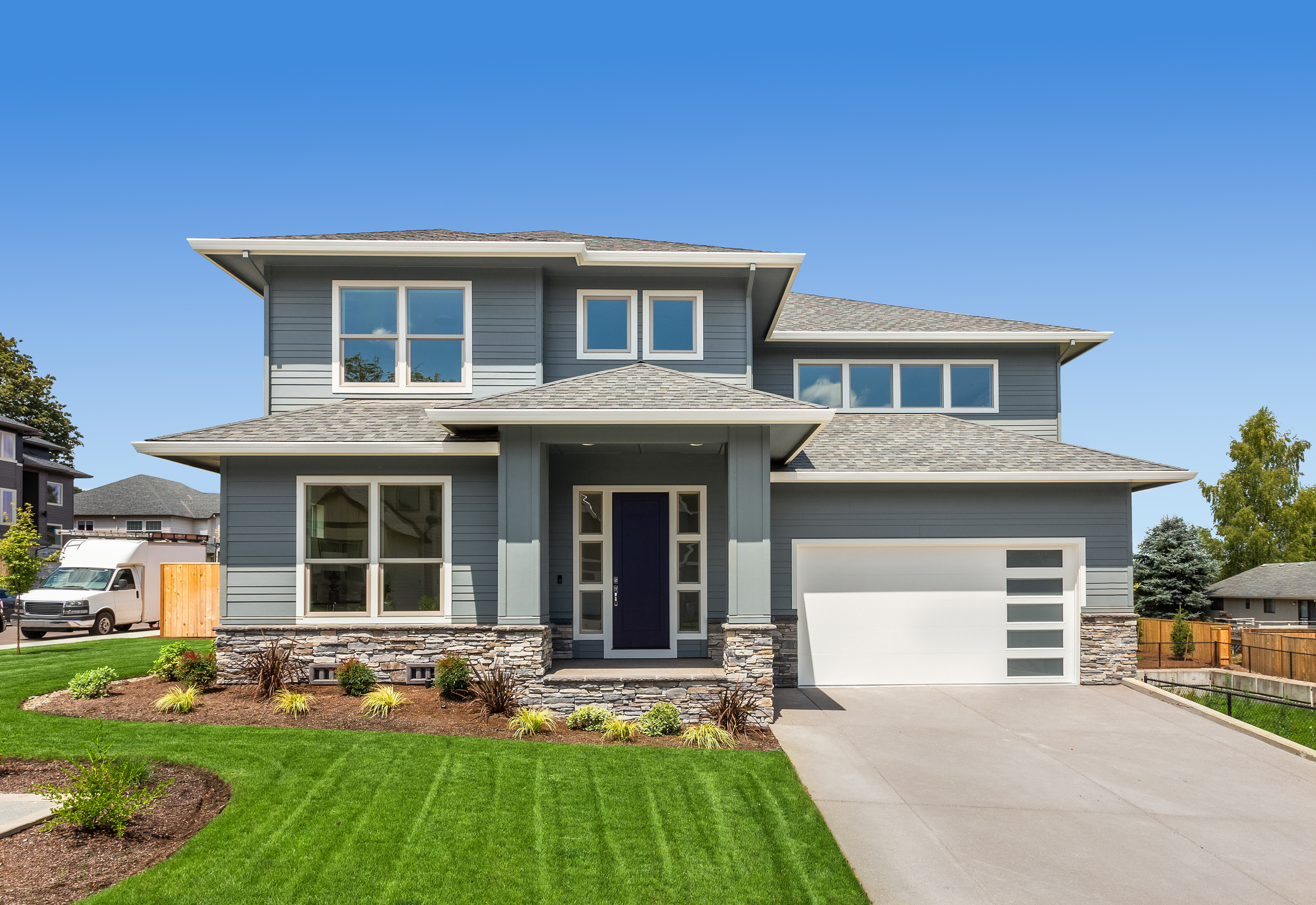 Modern home exterior featuring professional slate grey paint and crisp white trim.