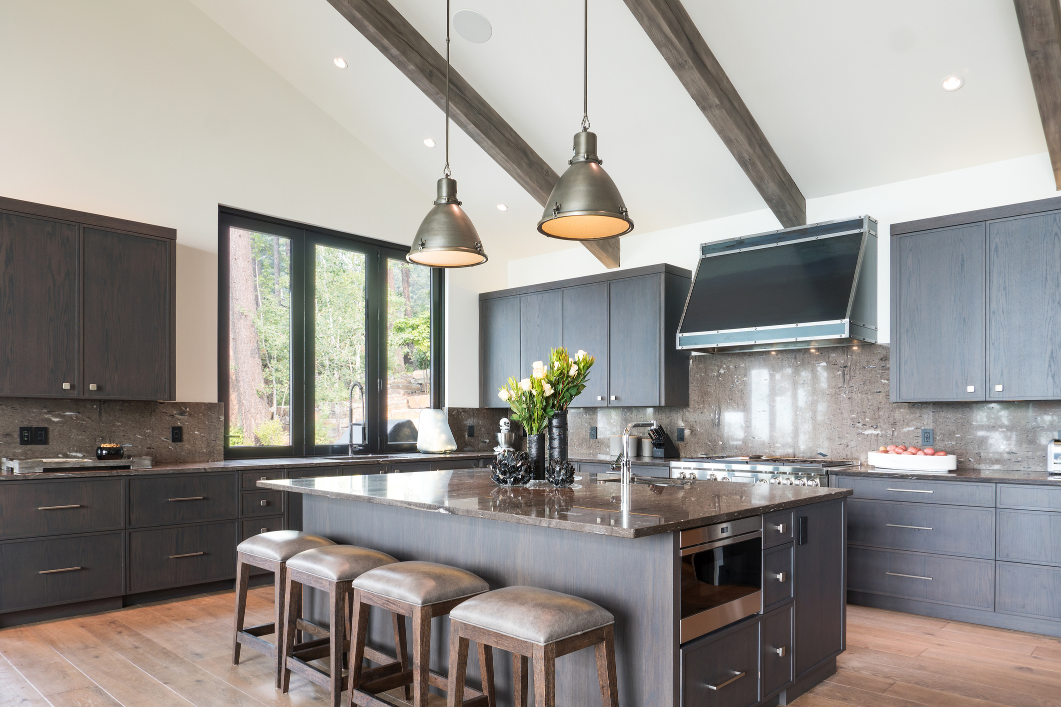 Professionally painted dark grey kitchen cabinets with a sleek modern finish.