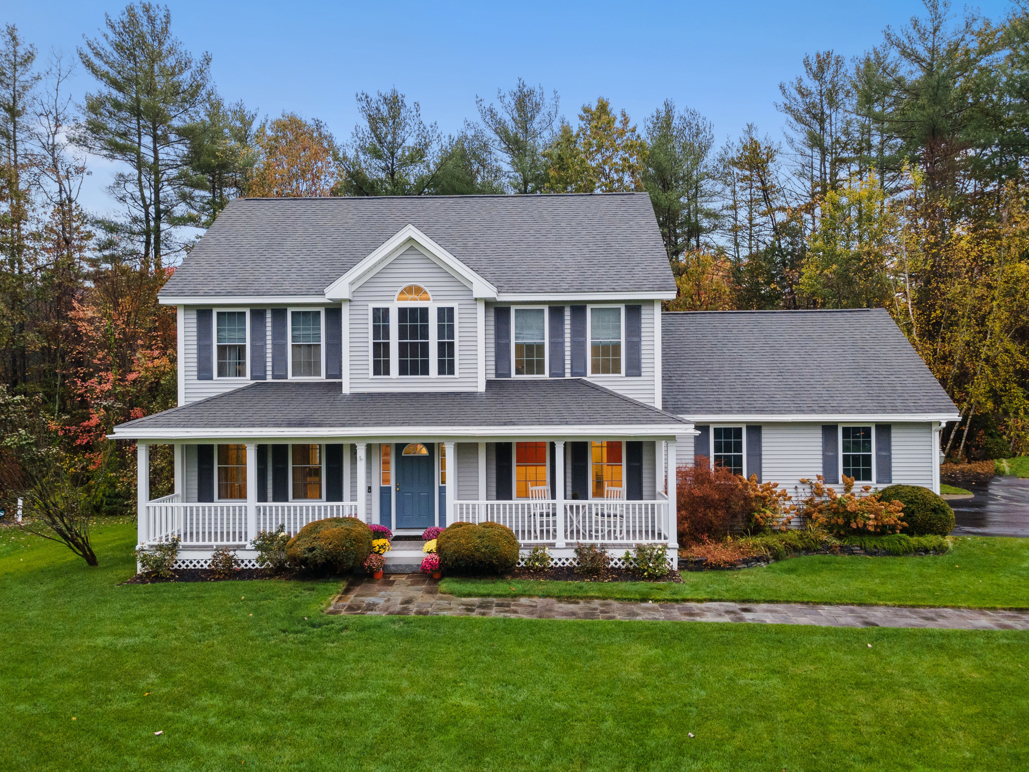 Gray exterior home paint job with white trim and porch.