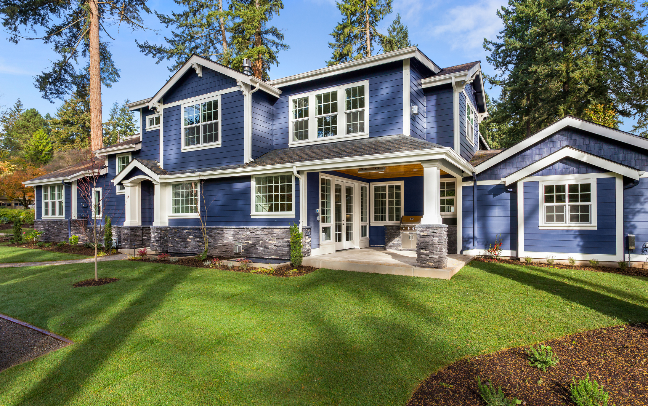 Side view of custom blue house exterior with professional paint job.